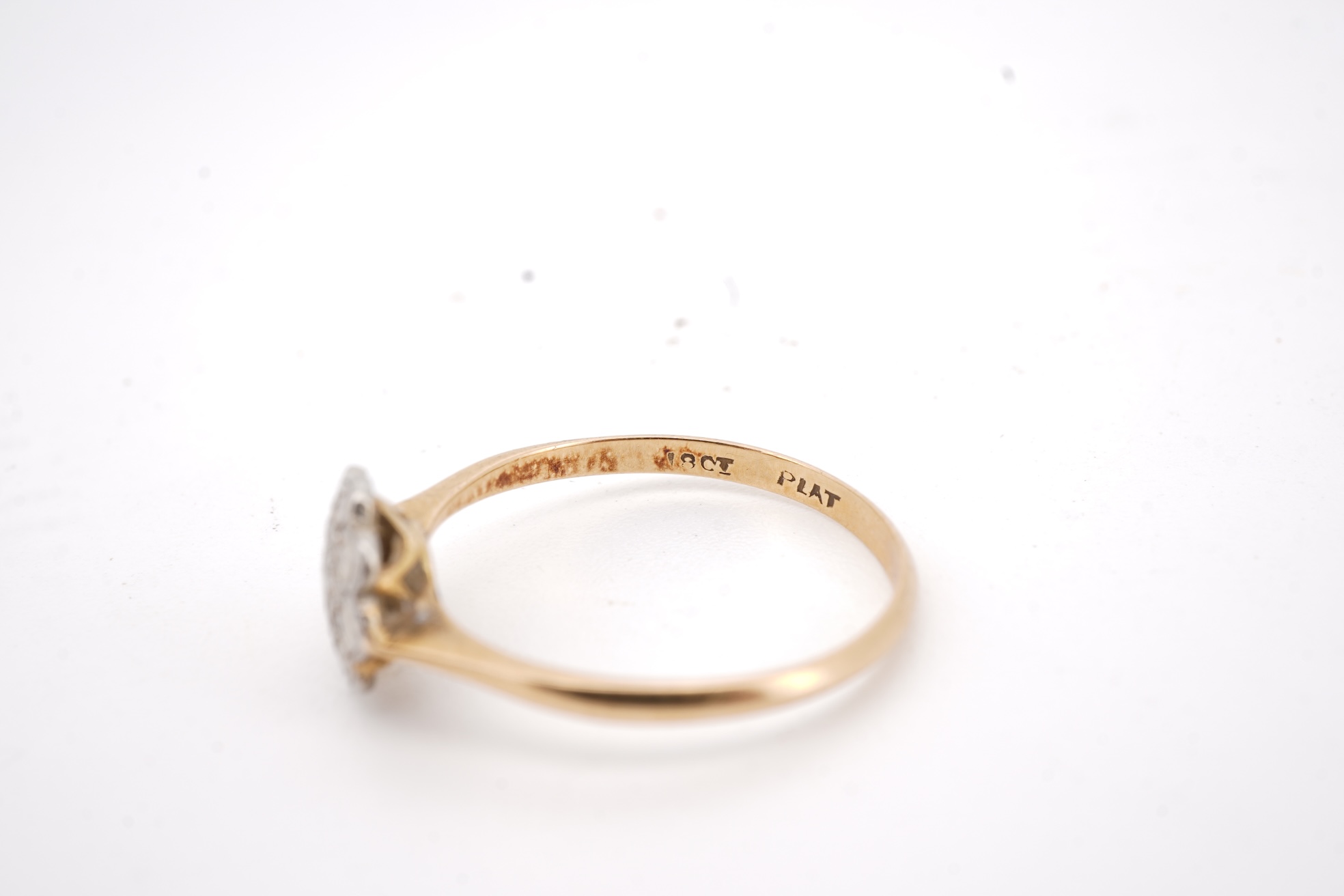 Three rings, comprising: a platinum wedding band, size N1/2, stamped PLAT, gross weight 3 grams; a bicoloured band, size J, stamped PLATINUM 22CT, gross weight 3 grams; and a ring set with a diamond weighing approximatel